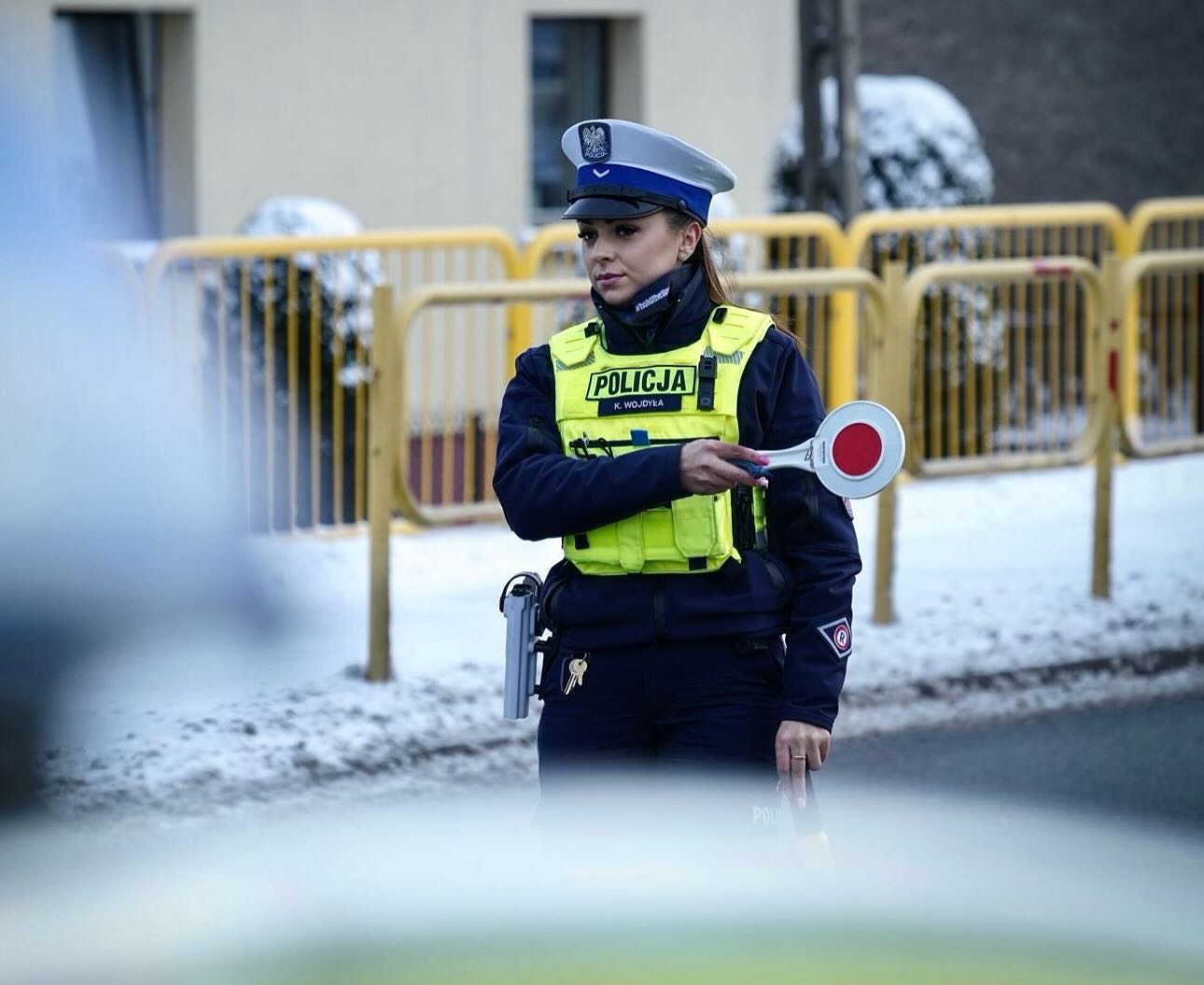 Policjantka wydziału ruchu drogowego w trakcie służby w kamizelce hold the line
